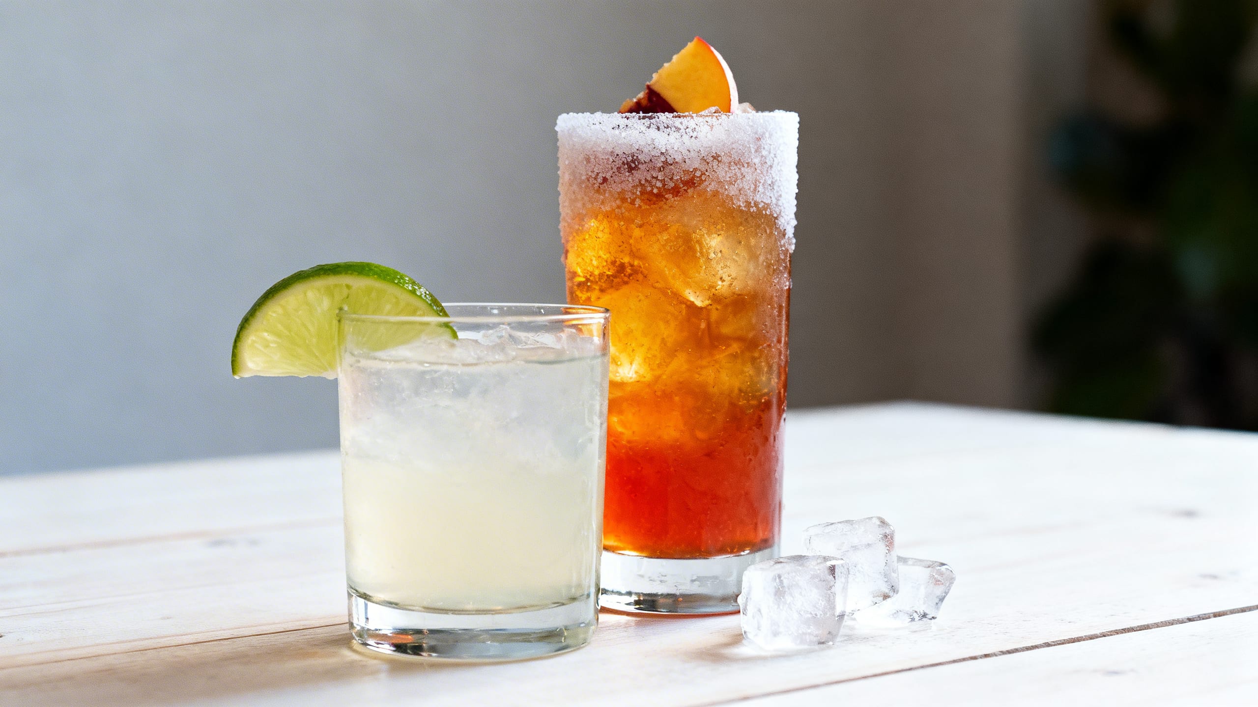 vodka soda with lime next to a sugary cocktail